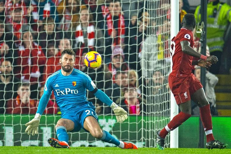 Liverpool forward Sadio Mane scoring an audacious back-heeled goal past Watford goalkeeper Ben Foster in the leaders' 5-0 Premier League victory at Anfield on Wednesday.