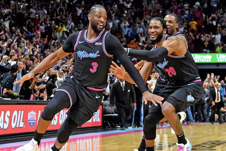 Miami Heat star Dwyane Wade (left) celebrating with Justise Winslow after making the game-winning basket against champions Golden State Warriors at American Airlines Arena.