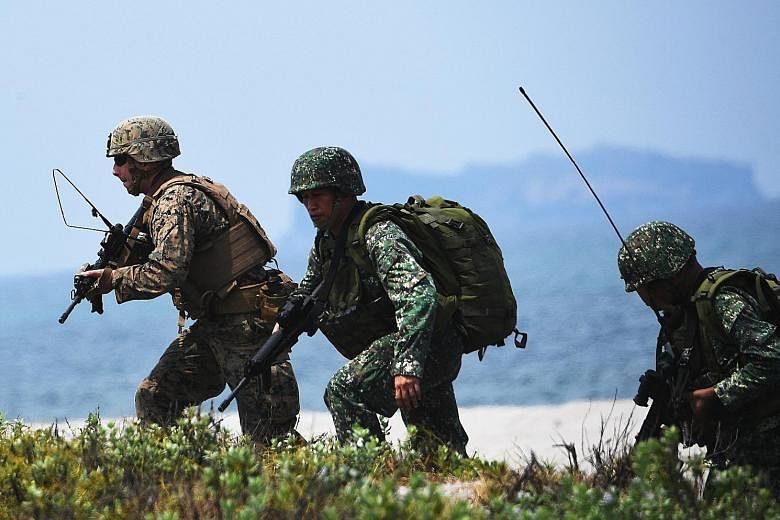 Philippine and US soldiers taking part in an annual joint military exercise in San Antonio in the Philippines' Zambales province last May. Regular war games are held between the two countries under their Mutual Defence Treaty.