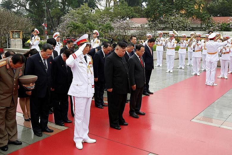 Mr Kim Jong Un attending a wreath-laying ceremony at the Monument to War Heroes and Martyrs in Hanoi yesterday. His trip to Vietnam was the first by a North Korean leader since 1964.