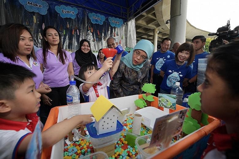 Eadlin Chua, 7, explaining a project to President Halimah Yacob as Environment and Water Resources Minister Masagos Zulkifli, PUB chief executive Ng Joo Hee and Senior Minister of State for the Environment and Water Resources Amy Khor listen on.
