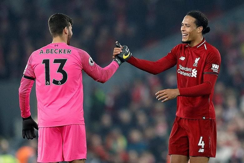 Liverpool defender Virgil van Dijk, with goalkeeper Alisson Becker, is expecting "a game full of passion" against Everton today at Goodison Park, which will host its 100th league meeting between the clubs.
