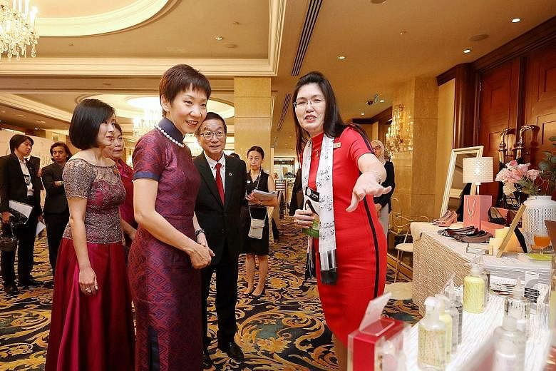 Minister for Culture, Community and Youth Grace Fu speaking to Ms Lynn Yap (right), founder of personal care products brand Clynn by Nature, at her booth at Marketplace by Crib yesterday. Crib is a non-profit group that helps build business networks 