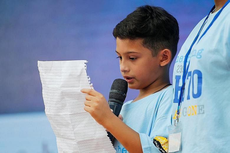 A girl with "MH370" painted on her cheek was among those at yesterday's ceremony. A recovered wing flap (left) and messages from families of the missing (below left) were on display. Rafael Gomes (below, right), grandson of missing in-flight supervis