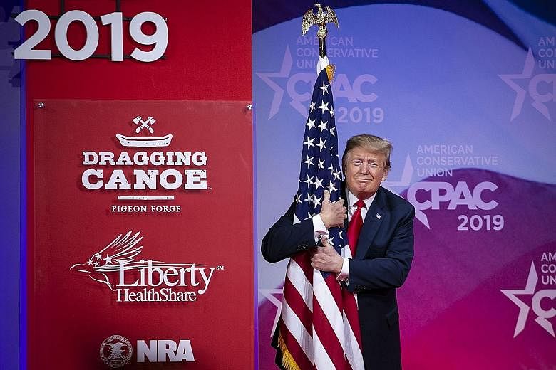 President Donald Trump hugging an American flag before speaking at the Conservative Political Action Conference in Maryland last Saturday. He spoke about the "socialist" ideas touted by the Democrats and vowed that America will never be a socialist c
