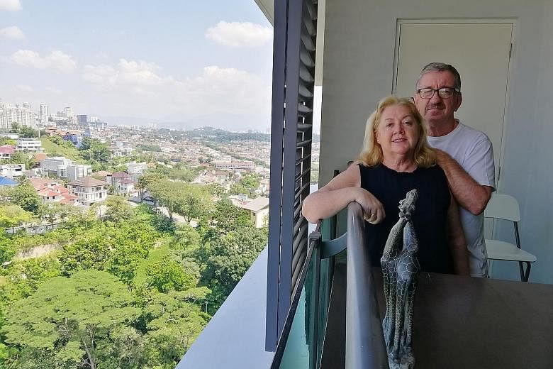 Mr Martin Walsh and his wife, Darina (above), in their Bangsar condo unit in Kuala Lumpur. The Irish couple have 10-year visas under the Malaysia My Second Home programme.Austrian citizen Markus Hoffman (left) lives in Penang under the same visa prog