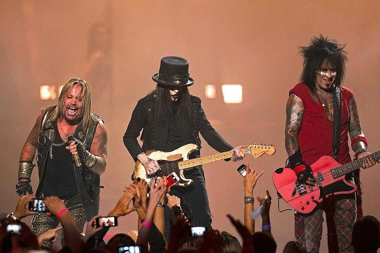 Motley Crue band members (from far left) Vince Neil, Mick Mars and Nikki Sixx playing at the 2014 iHeartRadio Music Festival in Las Vegas.