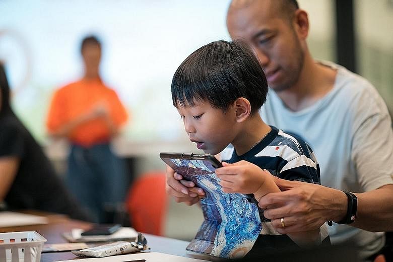 A father working with his son on a computational thinking activity at a workshop conducted under the Tiny Thinkers initiative last week.