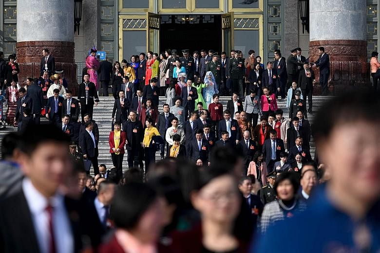 Delegates leaving the Great Hall of the People yesterday after a preparatory meeting ahead of today's opening session of the National People's Congress in Beijing. It will kick off with Premier Li Keqiang delivering the annual Budget. Market and poli