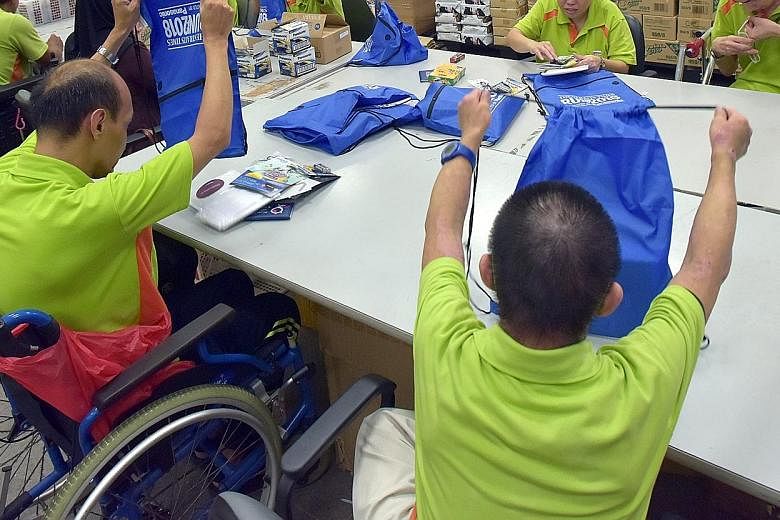 People from SPD, a charity for those with disabilities, packing bags for last year's ST Run. Ms Indranee Rajah said tertiary institutes help students with special needs build up their confidence and independence.
