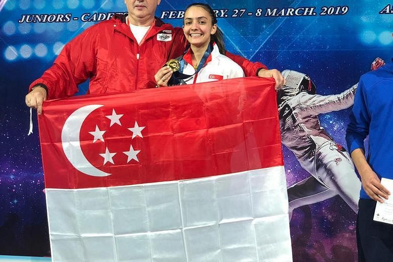 Amita Berthier posing with her gold medal with national coach Andrey Klyushin on Sunday after winning the junior (Under-20) final at the Asian Junior and Cadet Fencing Championships in Amman, Jordan. Below: Amita in action against Yang Chin-man of Ch