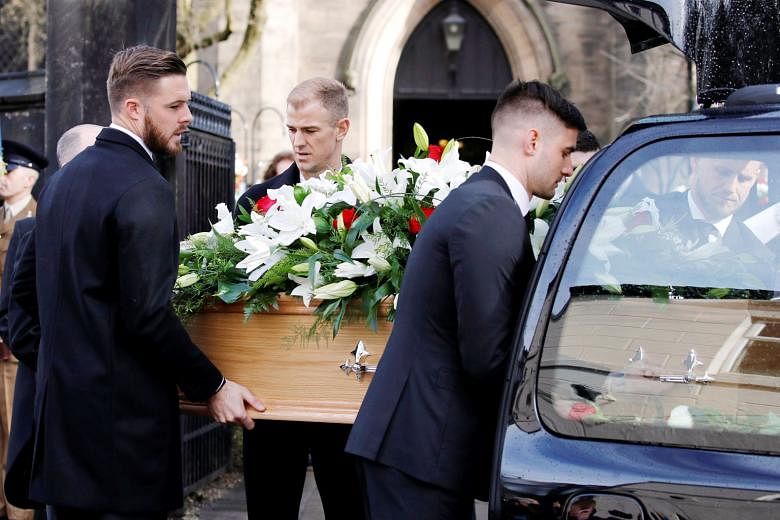 The coffin of England's World Cup-winning goalkeeper Gordon Banks being carried to the Stoke Minster church by four goalkeepers representing his three former clubs and England: Stoke's Jack Butland, Chesterfield's Joe Anyon, Leicester's Kasper Schmei
