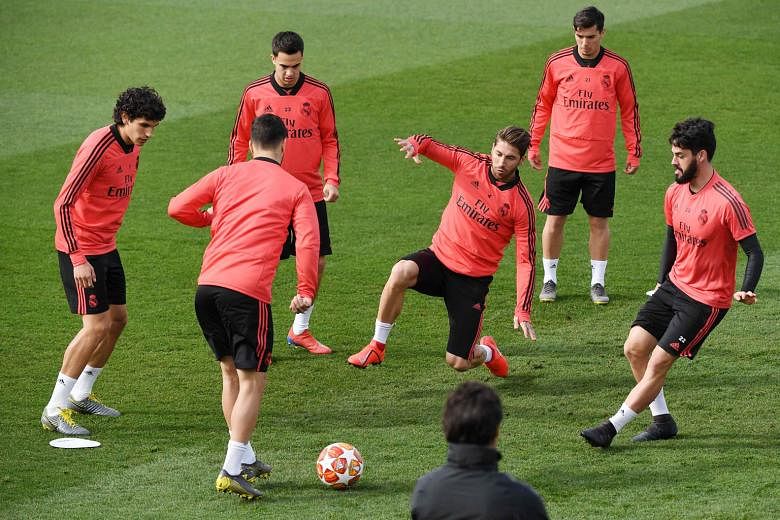 Real Madrid captain Sergio Ramos (centre) attempting to intercept a pass during training at the Valdebebas training complex in Madrid yesterday. The defender will be suspended for the Champions League last-16, second-leg tie against Ajax. Real lead 2