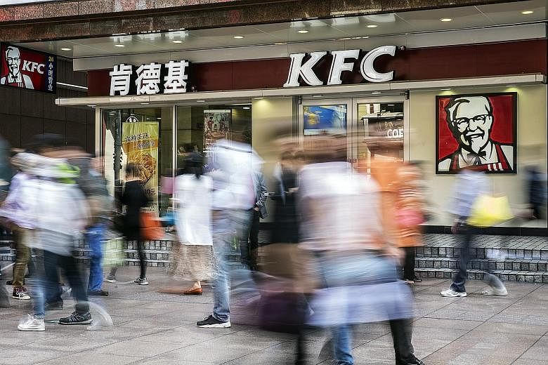 A KFC restaurant in Shanghai. Yum China has amassed a trove of spending and demographics data, allowing it to better forecast demand, cut food waste and boost profit margins. The savings have helped it avoid raising prices. A customer using the Smile