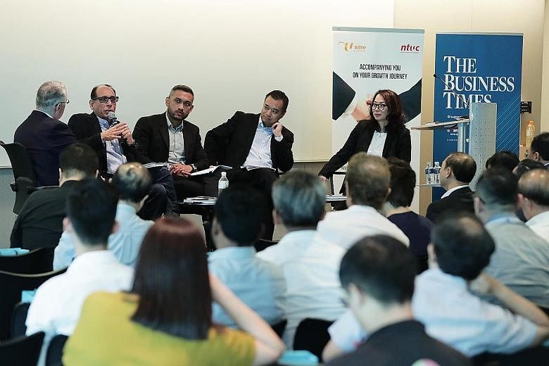 (From left) Singapore International Chamber of Commerce chief executive Victor Mills moderating the panel discussion, which featured The Straits Times' associate editor, Mr Vikram Khanna; Mr Ahmad Nazmi Idrus, a senior economist at RHB Investment Ban