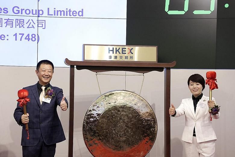 Mr Zhang Yong and his wife, Ms Shu Ping, preparing to strike a gong during Haidilao's listing ceremony in Hong Kong last September. The Chinese hotpot restaurant chain was founded in 1994 and now has about 370 outlets in China, and some 30 branches o