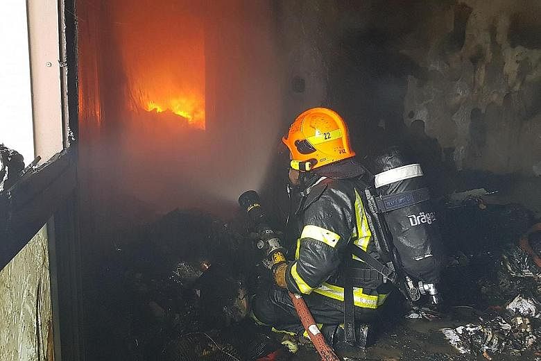 Firefighters wearing breathing apparatus had to forcibly enter the flat. Fire had engulfed the entire unit due to the vast accumulation of combustible items inside, said the Singapore Civil Defence Force.