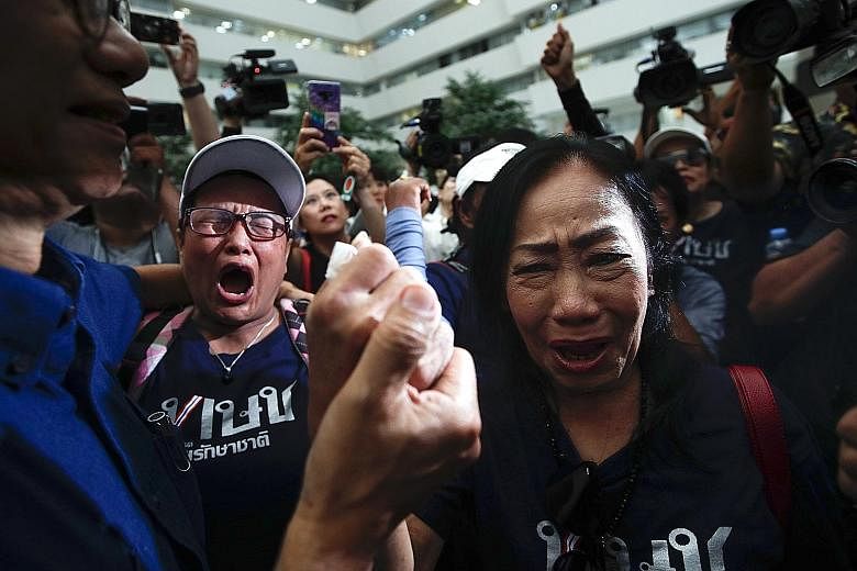 Supporters breaking into tears after Thailand's Constitutional Court ordered the dissolution of the Thai Raksa Chart Party in Bangkok yesterday.