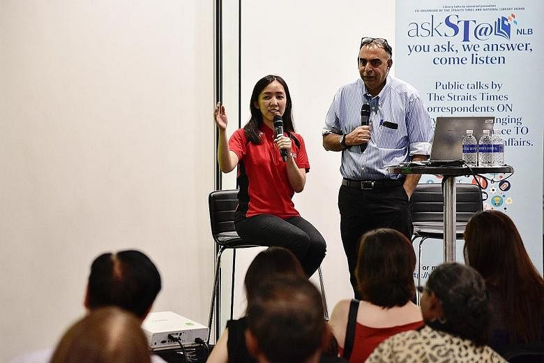 National shooter Jasmine Ser and The Straits Times assistant sports editor Rohit Brijnath speaking at askST@NLB at the Central Public Library yesterday. Ser shared with the 150 readers about the pressures of being an athlete, and also about how she w