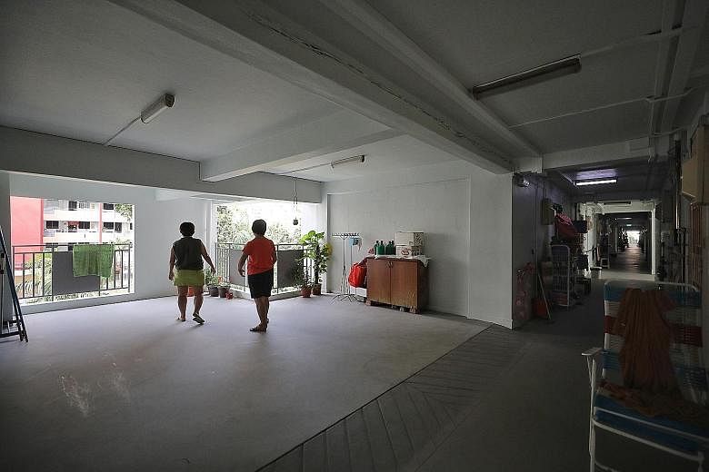 Neighbours Teo Geok Lan (right), 61, and Leong Lye Chan, 57, socialise at an open space where a one-room unit used to be on the fifth floor of their block. The corridors are now brighter and more airy, says Madam Leong.