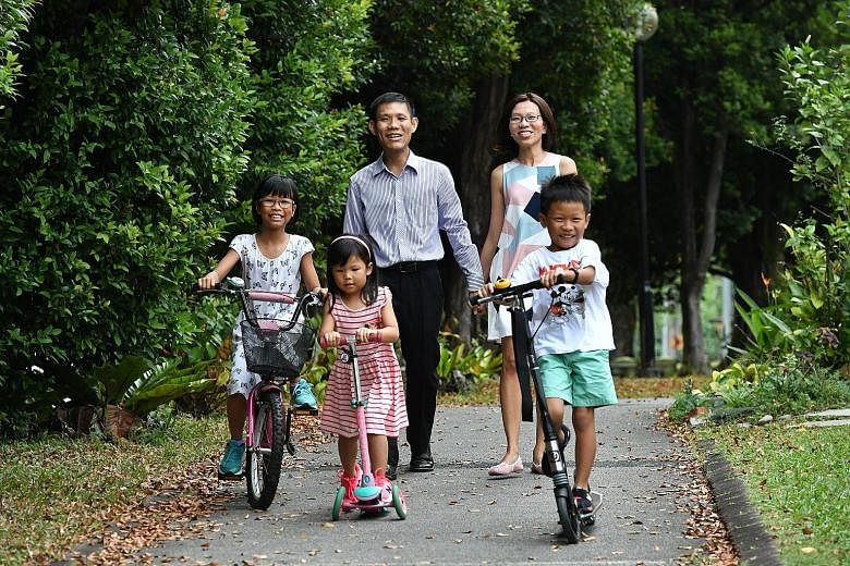 Financial services executive Derek Liang with his wife, Ms Lynne Tan, and their three children, Sarah (far left), Hannah and Joseph.