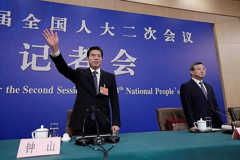 Chinese Commerce Minister Zhong Shan (left) and Vice-Minister Wang Shouwen at a news conference in Beijing yesterday. Mr Wang says Chinese and US negotiators are working on the final text of a trade agreement.