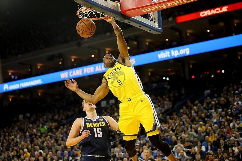 Golden State Warriors guard Andre Iguodala dunking the ball against the Denver Nuggets at the Oracle Arena on Friday night. The Warriors (45-20) won 122-105 to increase their lead over the Nuggets (43-22) in the play-off race.