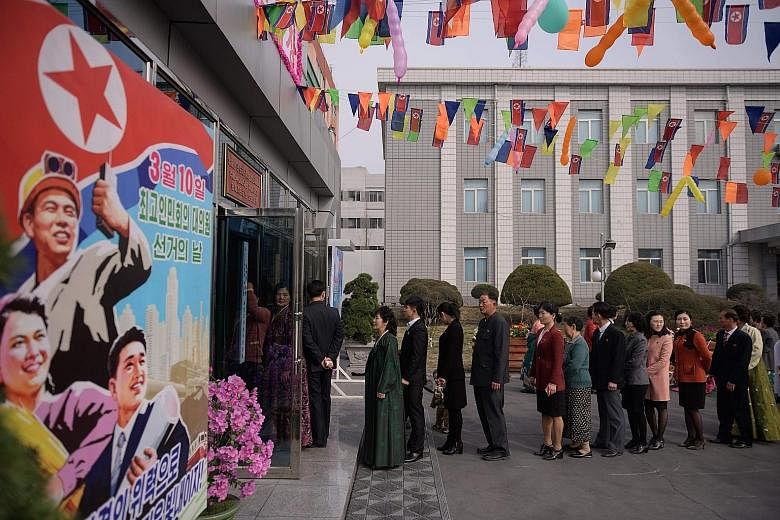 Voters queueing to cast their ballots at a voting centre in Pyongyang.