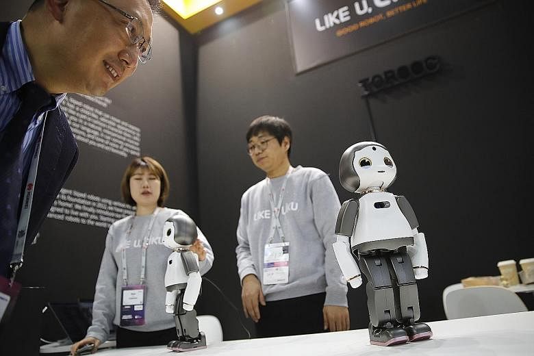 Liku baby humanoid robots being demonstrated at the Mobile World Congress in Barcelona last month. Survey respondents may say they've deployed a specific AI-based technology, such as chatbots or face recognition, but it may mean bots that merely prov