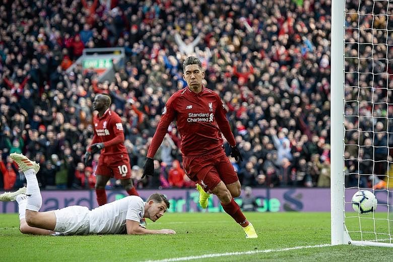 Liverpool forward Roberto Firmino celebrating his second and the Reds' third goal in the 4-2 victory over Burnley at Anfield yesterday. The Brazilian and teammate Sadio Mane each scored a brace to help the Reds overcome a controversial opener from th