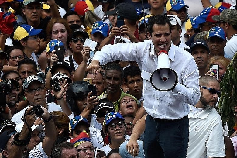 Opposition leader Juan Guaido speaking at a rally in Caracas on Saturday. A massive blackout since Thursday has crippled Venezuela and fuelled a political stand-off between Mr Guaido and embattled President Nicolas Maduro, who is clinging to power.