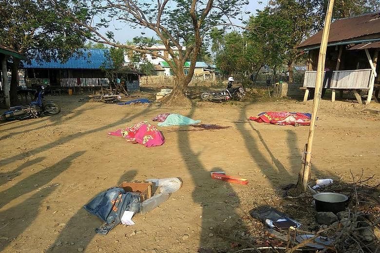 The covered bodies of policemen killed in a militant attack on Saturday at Yoetayoke village, near Rakhine state's capital Sittwe.