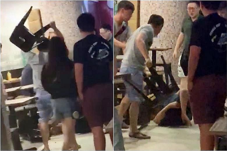 A video of the fight shows a man curled up on the floor of Liang Court's foodcourt while being beaten by two others. One of the men then uses a stool to hit the man on the floor.