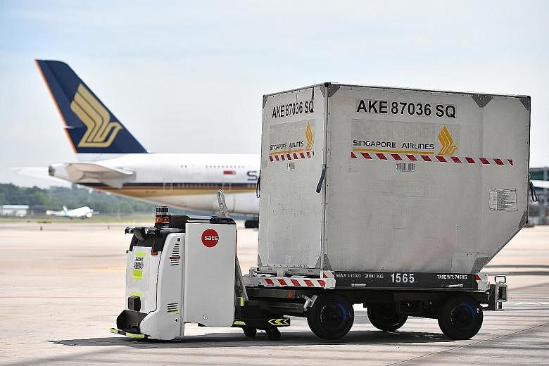 An Autonomous Guided Vehicle with a container trailer at Changi Airport. At the new Changi East industrial complex, air freight terminals will be highly automated and data-driven.