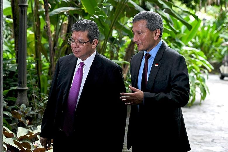 Malaysian Foreign Minister Saifuddin Abdullah (left) says Dr Vivian Balakrishnan's comments are "reckless".