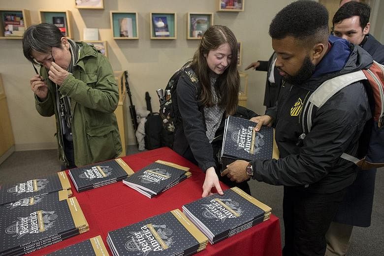 Members of the public picking up copies of President Donald Trump's budget plan - a record US$4.75 trillion (S$6.4 trillion) - at its release in Washington DC on Monday. The budget is considered dead on arrival in the House, which is led by Democrats