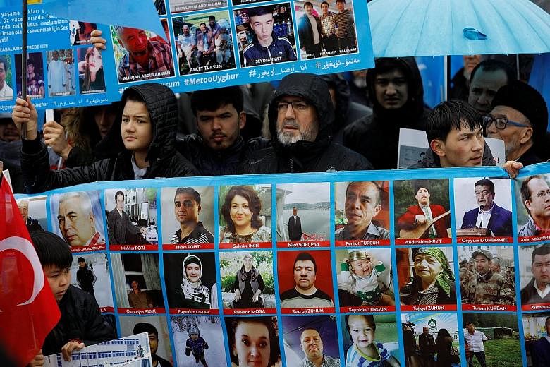 Ethnic Uighur protesters with portraits of their relatives said to be missing during a demonstration last month against China in Istanbul. The governor of Xinjiang, Mr Shohrat Zakir, yesterday dismissed Turkey's description of the region's re-educati
