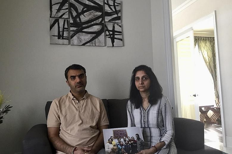 Mr Manant Vaidya and his wife Hiral with a family picture. Three generations of Mr Vaidya's Canadian-Indian family died in the Ethiopian plane crash - his parents, sister, brother-in-law and two teenage nieces.