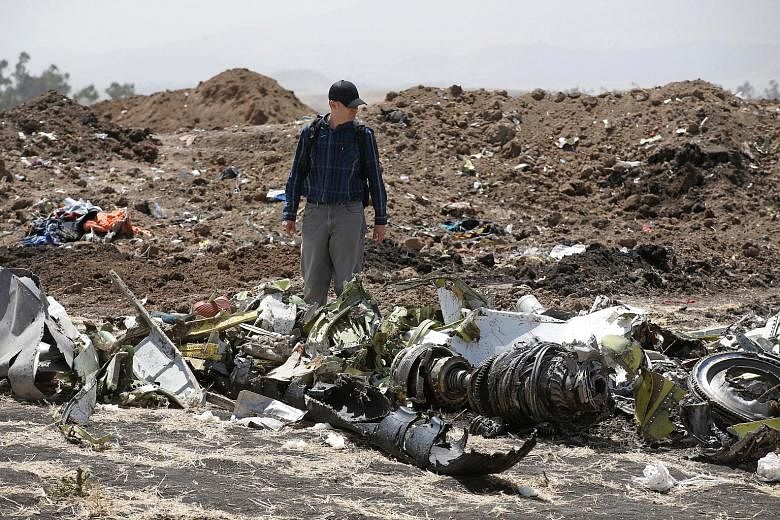 An investigator at the scene of the Ethiopian Airlines crash near the town of Bishoftu, south-east of the country's capital Addis Ababa, on Tuesday. All 157 people aboard Flight 302 bound for Nairobi were killed in the crash on Sunday.