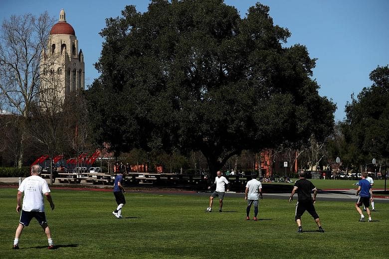 People playing football at Stanford University earlier this week. The university is among top schools named in the US Justice Department's largest-ever college admissions prosecution, resulting in charges against 50 people.