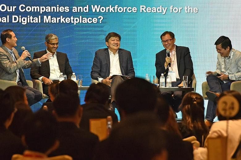 At yesterday's panel discussion were (from left) Mr Tan Kiat How, chief executive of the Info-communications Media Development Authority; Mr Abraham Thomas, managing director of IBM Singapore; Mr Ng Chee Meng, Minister in the Prime Minister's Office 