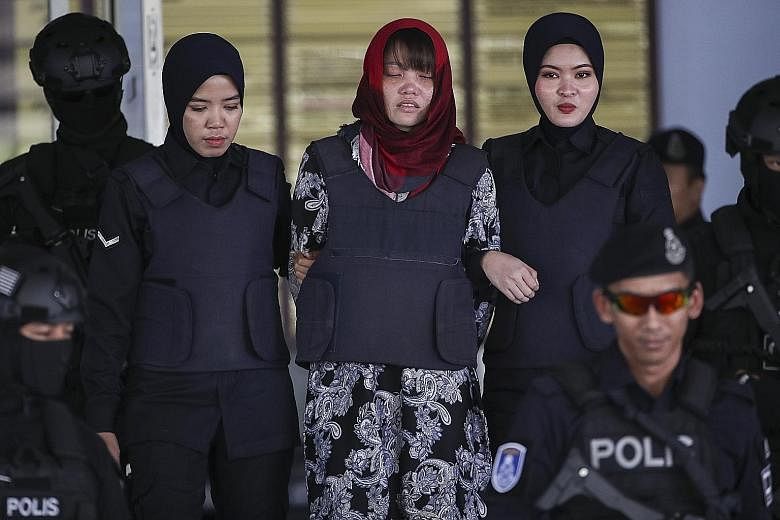Vietnamese Doan Thi Huong being escorted out of the Shah Alam High Court yesterday. Huong and Indonesian Siti Aisyah were both charged over the murder of North Korean leader Kim Jong Un's half-brother in 2017, but Jakarta lobbied successfully for cha