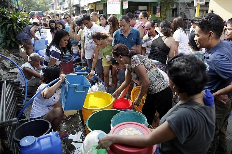 Waiting to fill buckets at a water distribution point in Mandaluyong city, east of Manila, on Wednesday. Manila Water, which supplies half of the capital region, said the situation will return to normal when the rains come.