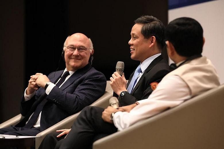 Trade and Industry Minister Chan Chun Sing speaking at the Singapore-France Economic Forum. With him are former French minister Michel Sapin and moderator Nitin Jaiswal from Bloomberg.
