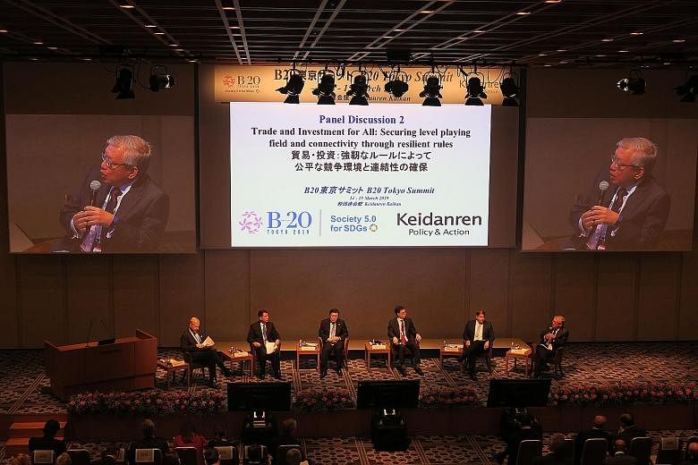 Singapore Business Federation chief executive Ho Meng Kit (right) speaking during a panel discussion on trade and investment at the Business 20 summit in Tokyo yesterday. The other panellists are (from left) Mr John Denton Ao, secretary-general, Inte