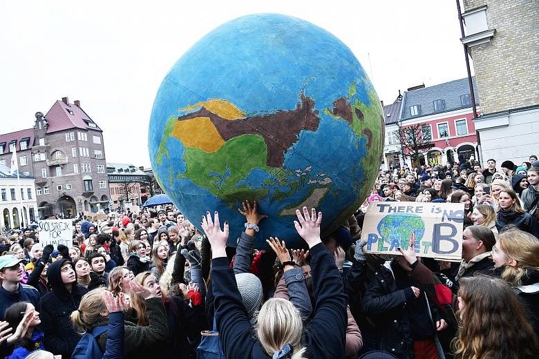Students from countries all over the world, such as (from left) Australia, Sweden and South Koreajoining the Global Climate Strike yesterday to pressure world leaders into action on climate change.
