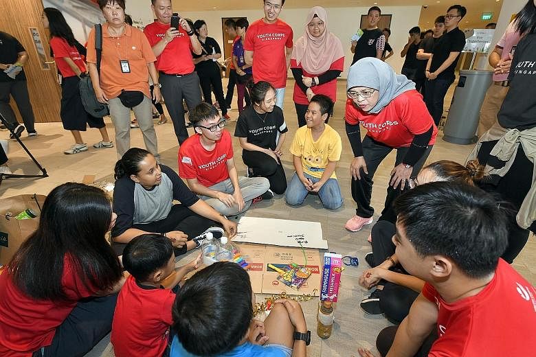 President Halimah Yacob taking part in activities with youth volunteers and beneficiaries at the launch of Youth Corps Service Week 2019.
