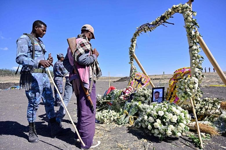 A flower memorial with portraits of some of the 157 victims of Ethiopian Airlines Flight 302 at Hama Quntushele village near Bishoftu in the Oromia region. One source who has listened to the air traffic control recording said a voice from the Boeing 