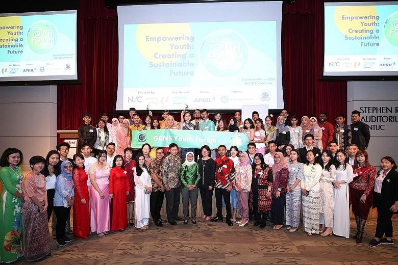 President Halimah Yacob (centre) with the Asean delegates at the Global Compact Network Singapore Youth Forum 2019 yesterday. About 300 local and foreign youth engaged Madam Halimah in a dialogue.