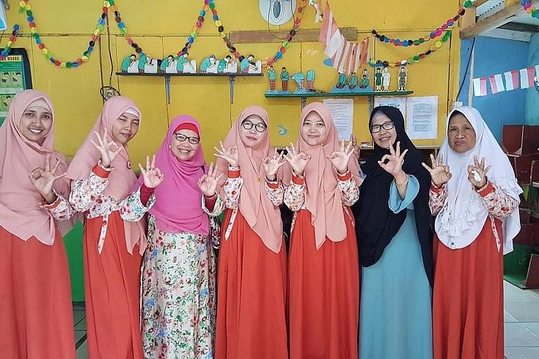Ms Dwi Septiawati Djafar (third from left) of the Prosperous Justice Party with her constituents. She is running for office in Bekasi, Karawang and Purwakarta regencies in West Java to push for the empowerment of women, children and families. The upc